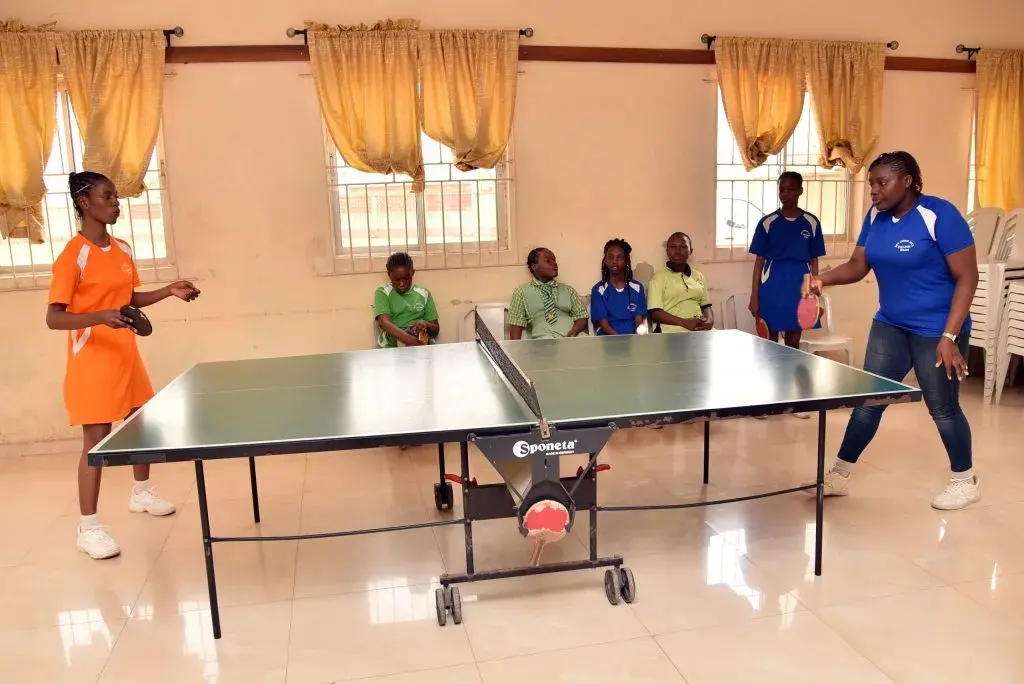 Student playing tennis